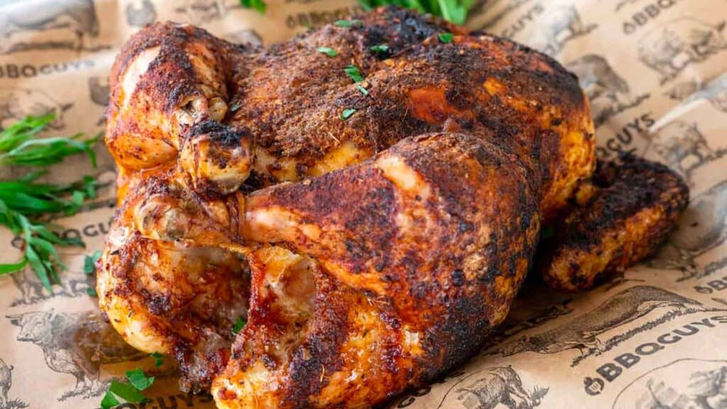 Whole chicken grilled on butcher paper.