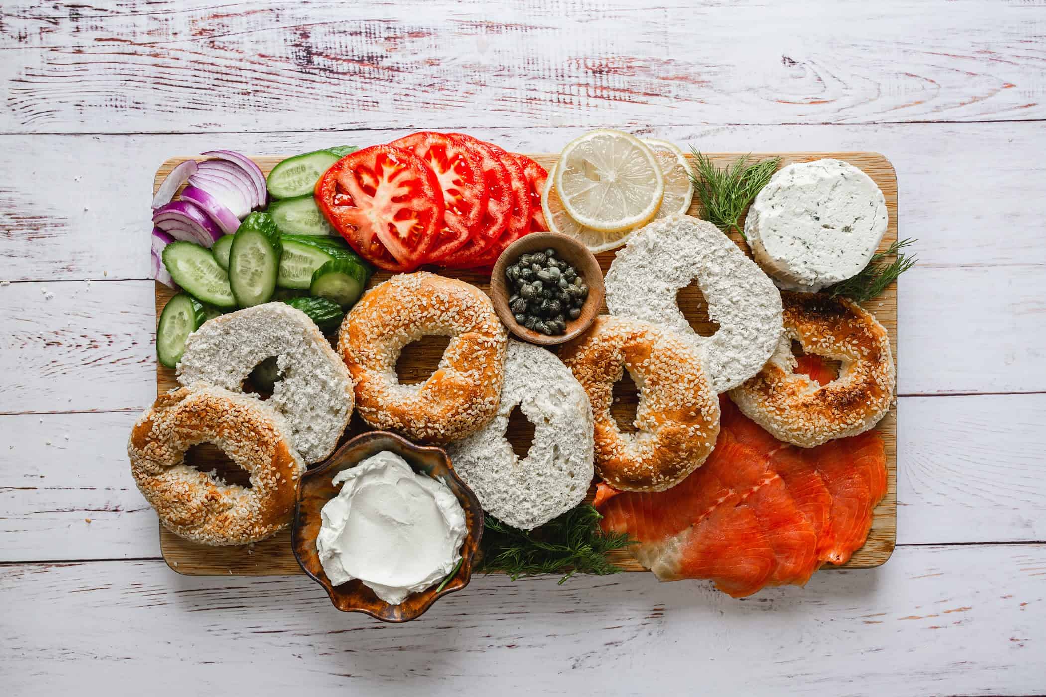 A lox and bagel board on a table.