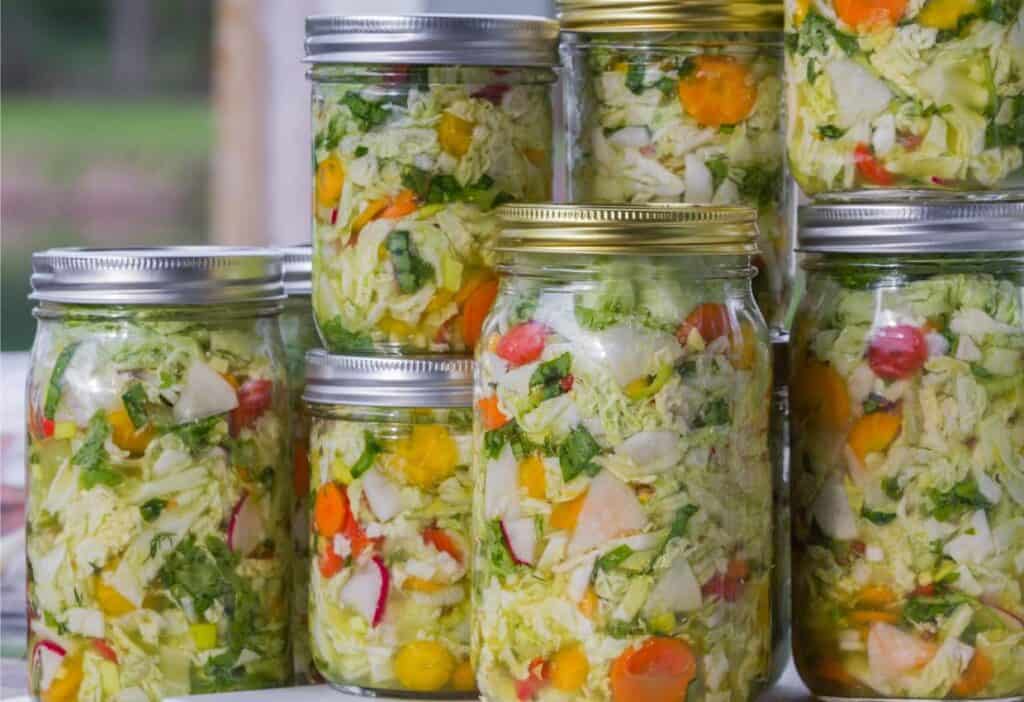 Mason jars of fermenting vegetables.