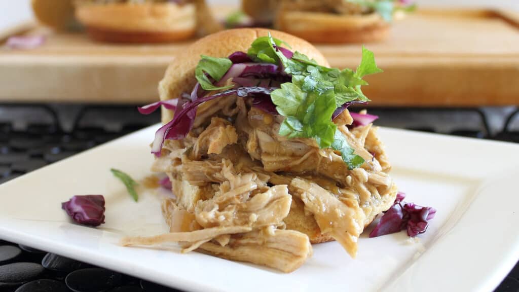 Mexican pulled pork sliders on a white plate.