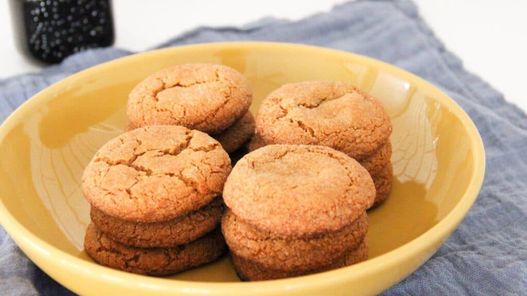 Old-fashioned molasses cookies in a yellow bowl.