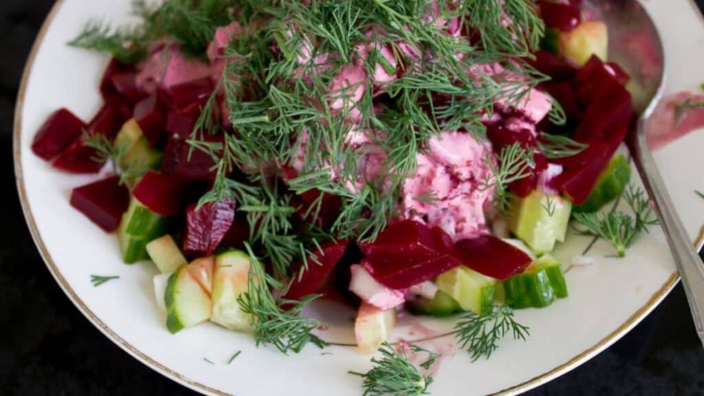 close up on beet cucumber salad with dill.