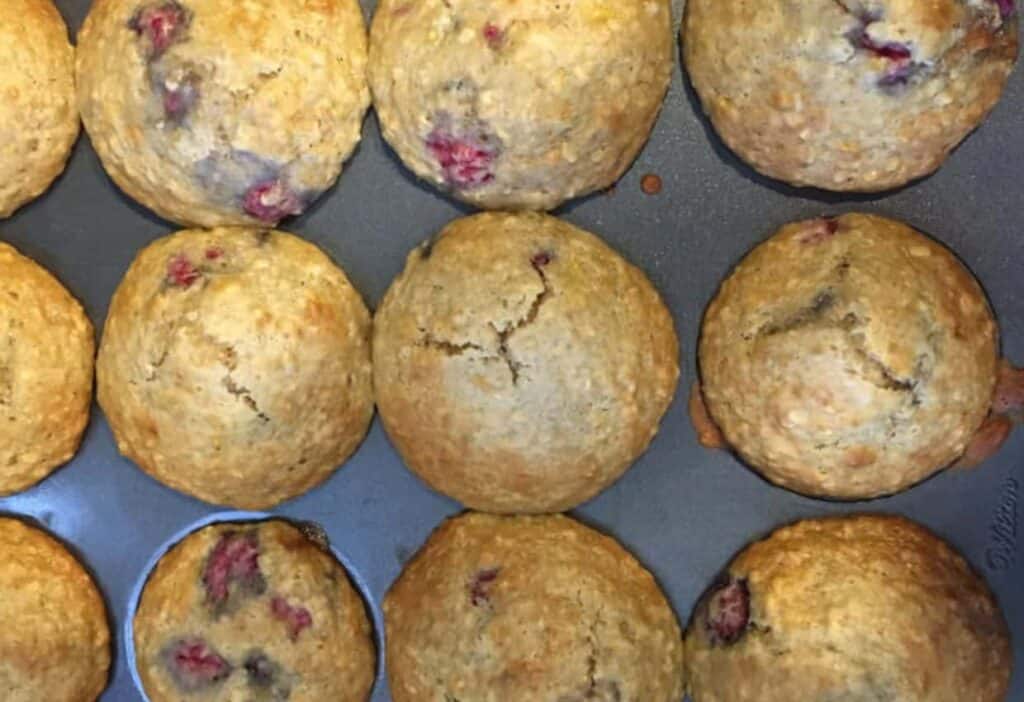 Raspberry lemon muffins in a muffin pan.