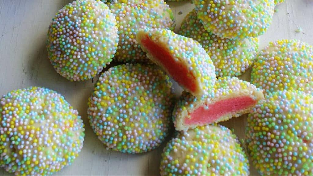 Raspberry cookies with pastel sprinkles.