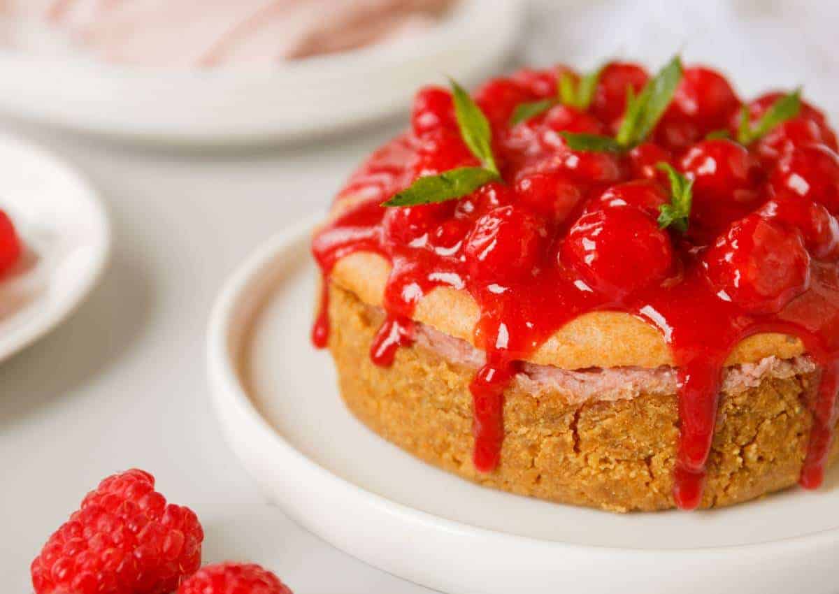 Raspberry lemon cheesecake topped with raspberry sauce.