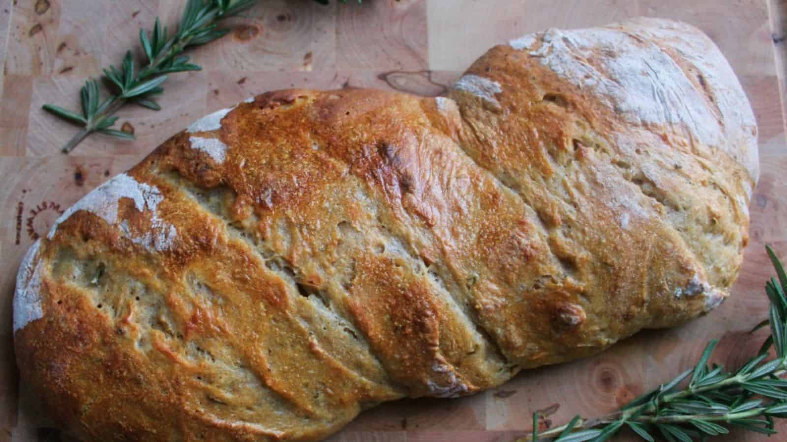 Rosemary sourdough bread on cutting board.