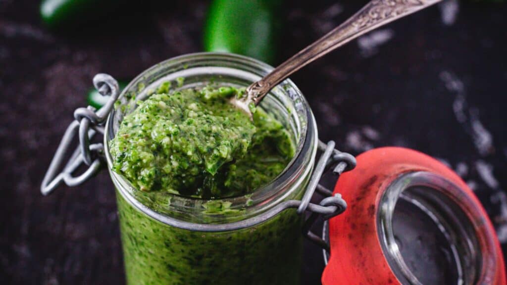 overhead view of green hot sauce in jar