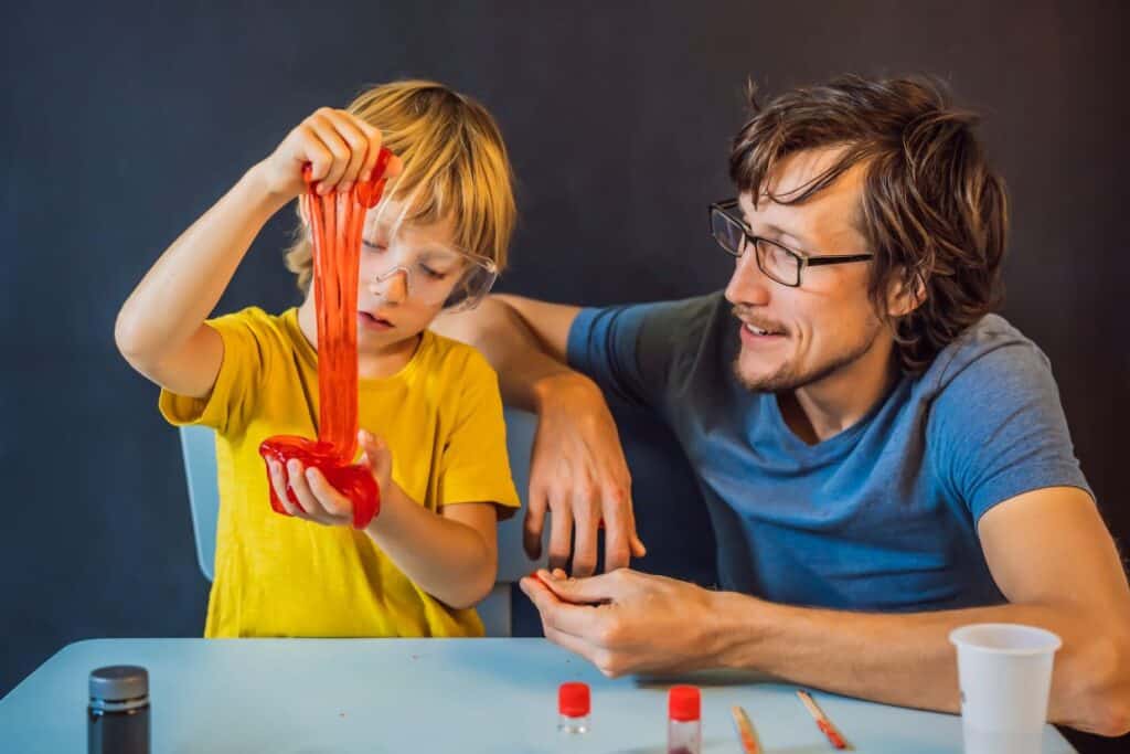 Father and son playing with slime.