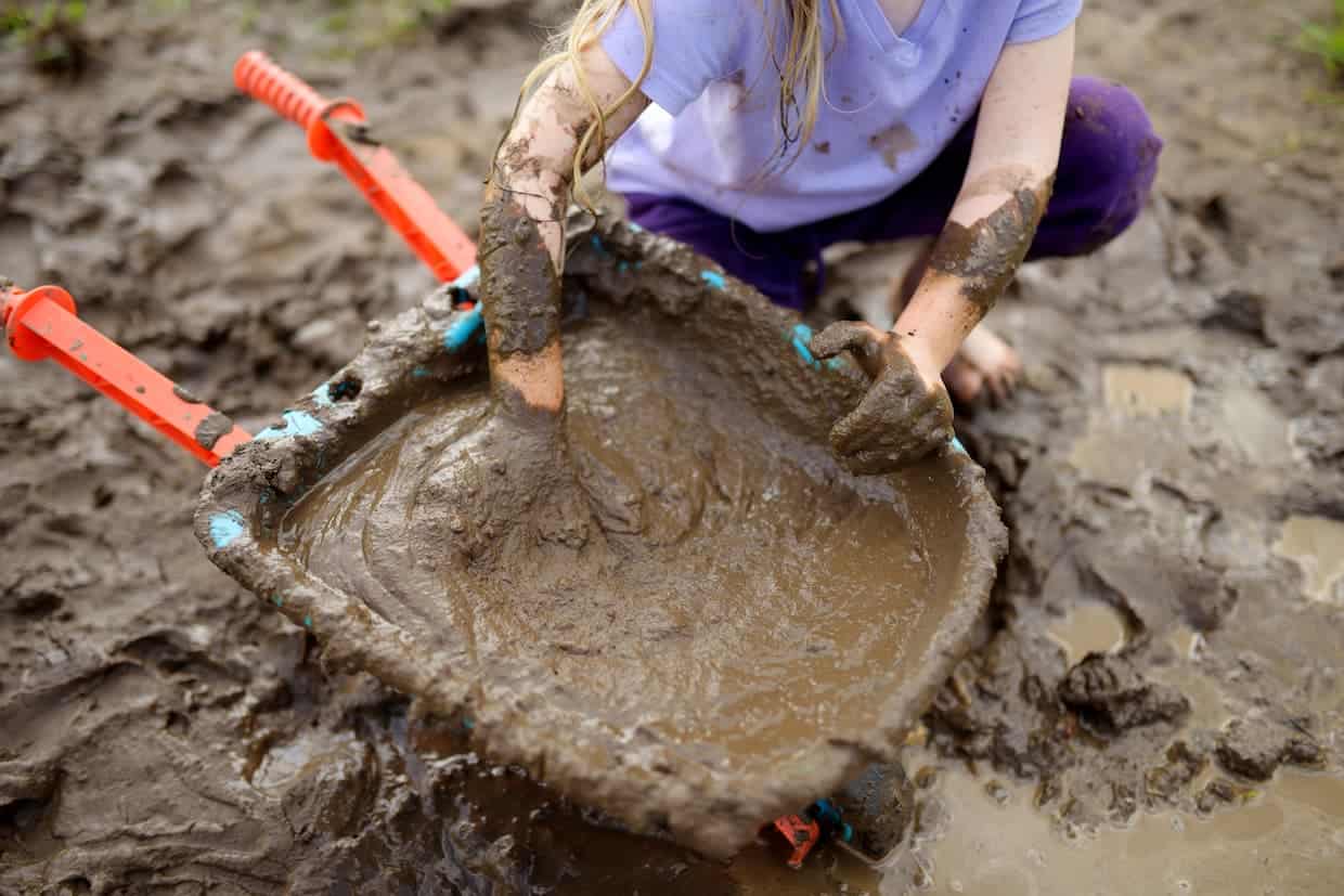 A girl playing with mud.