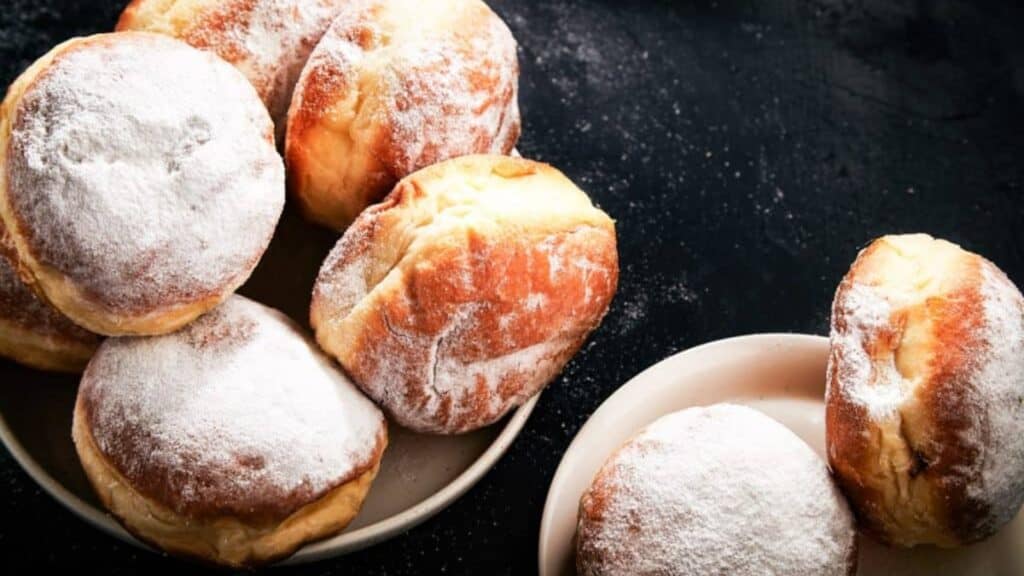 Low angle shot of Israeli donuts or sufganiyot with powdered sugar on top.