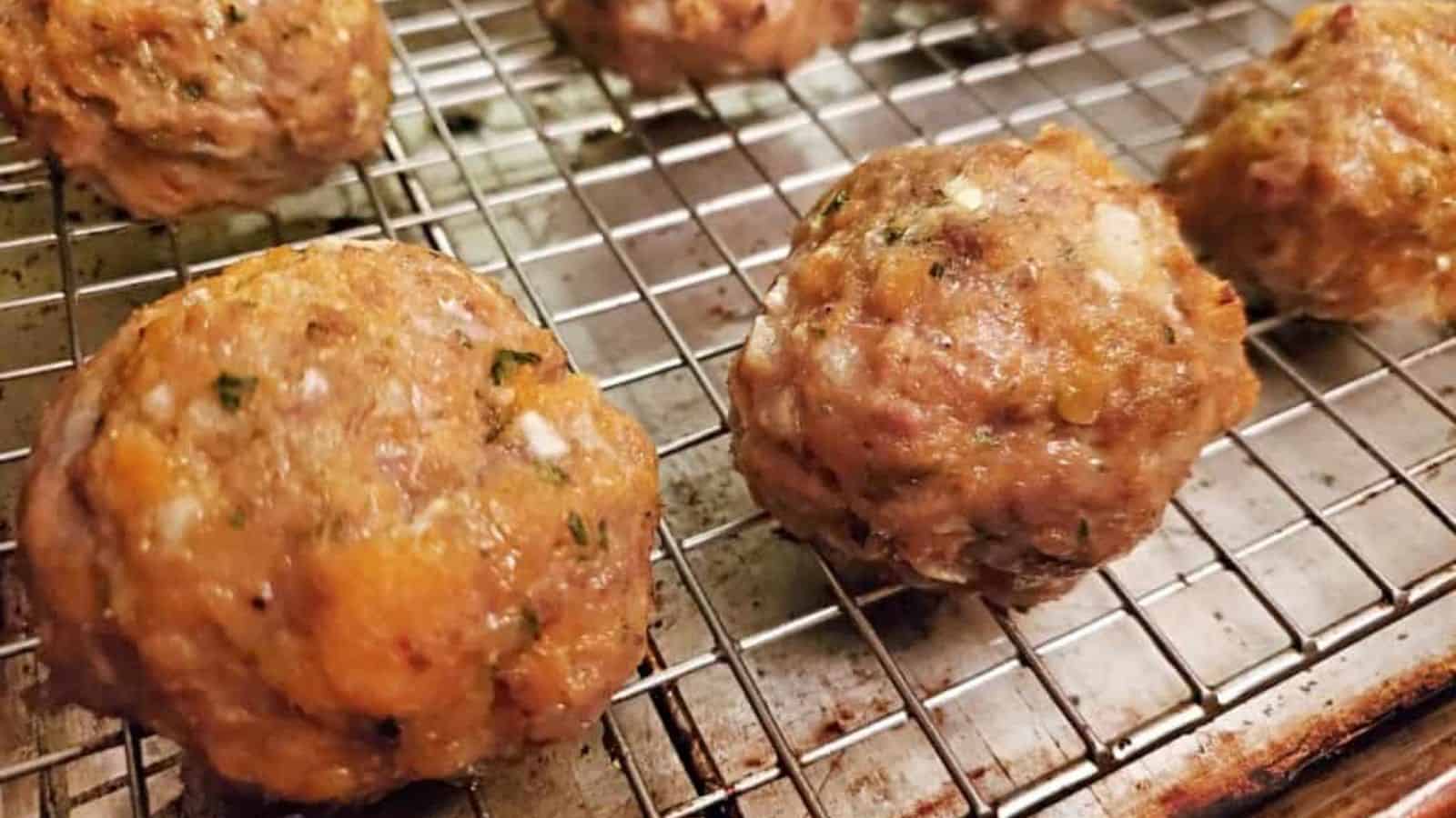 Image shows a baking sheet with a raised tray holding Sweet Potato Turkey Meatballs.
