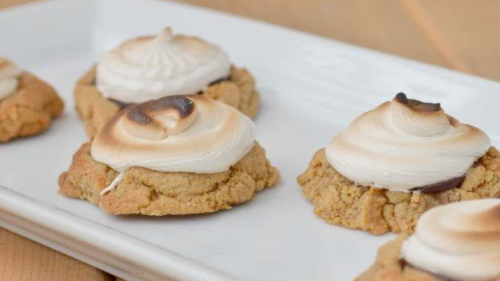 Image shows Toasted smores cookies on a white tray.