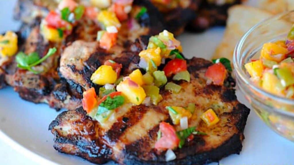 Grilled pork chops with green chili salsa.