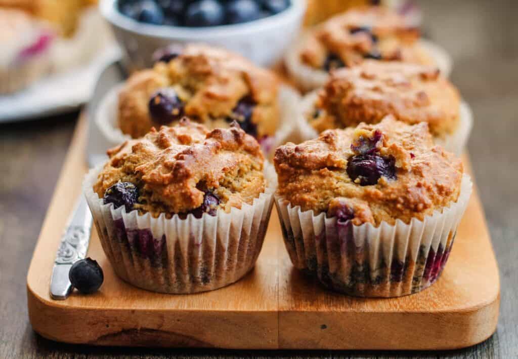 blueberry muffins on a board.