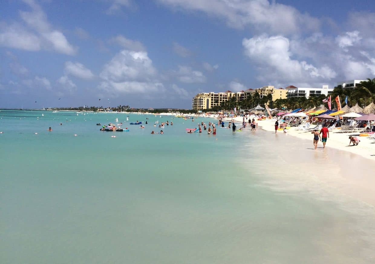 Aruba beach with tourists and hotels.