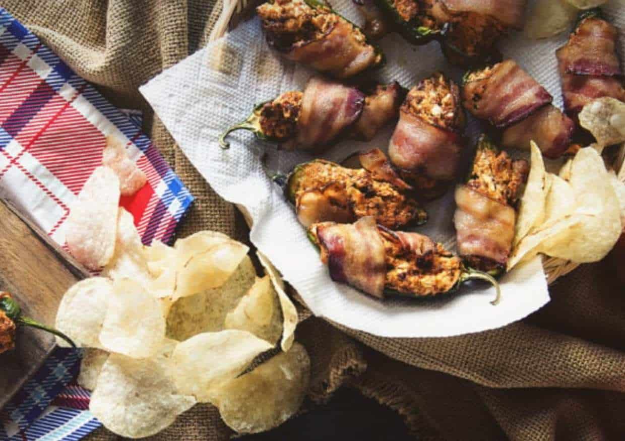 Bacon wrapped poppers on tray.