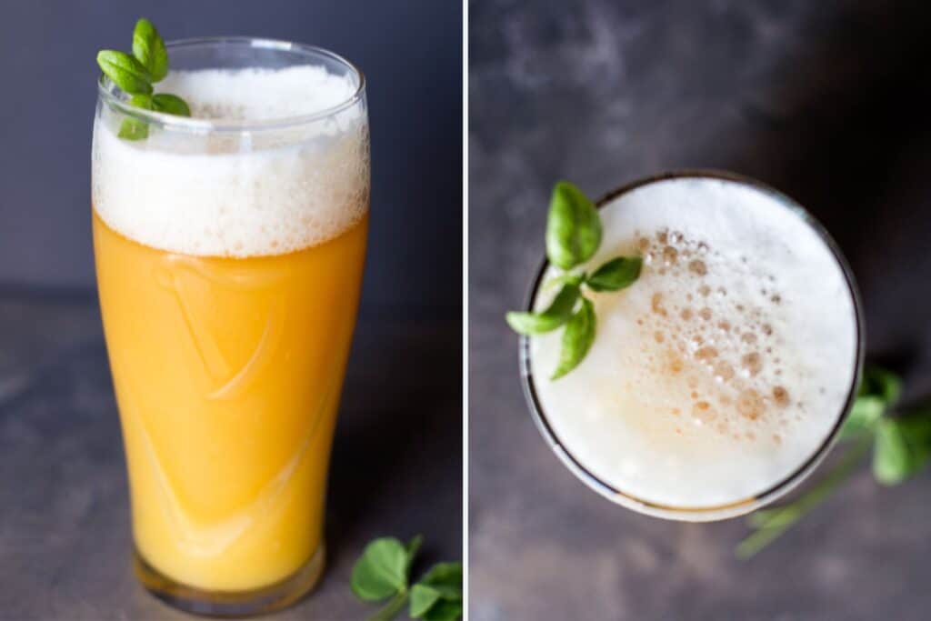 Pint glasses containing a beermosa made of orange juice and beer.