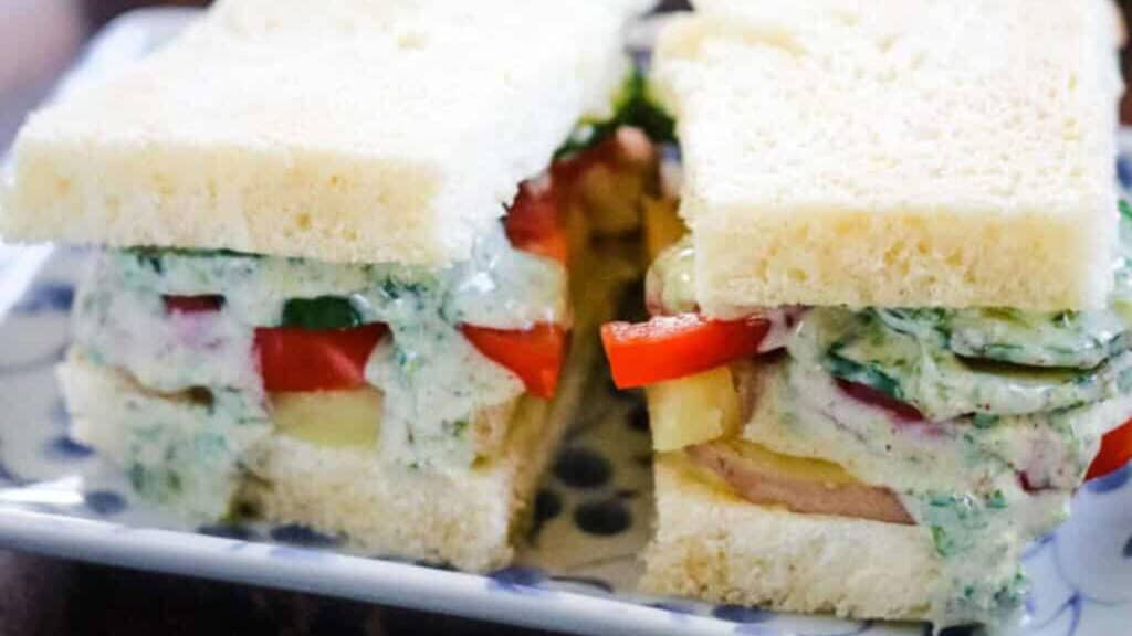 A bombay sandwich on a blue and white plate.