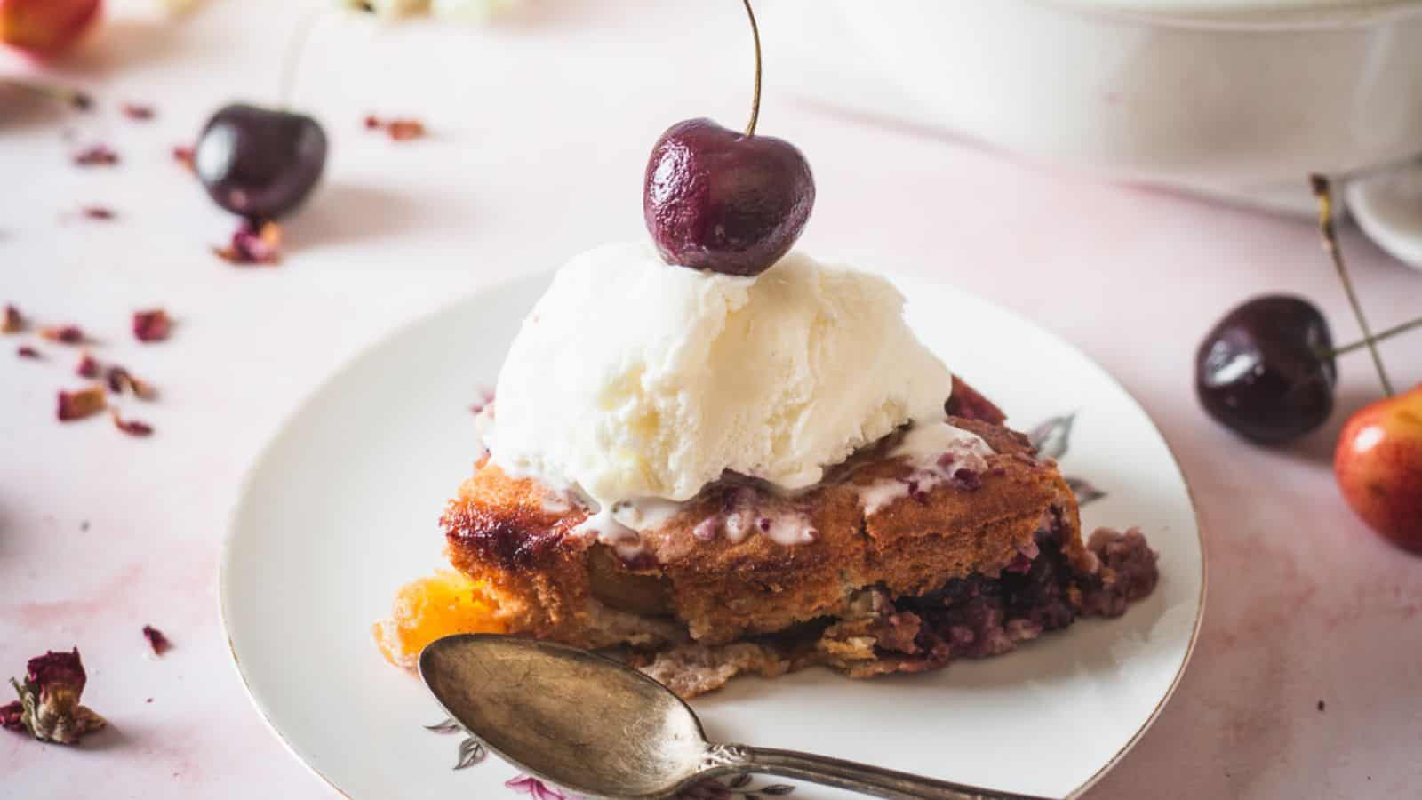 side view of slice of cherry cobbler with ice cream.