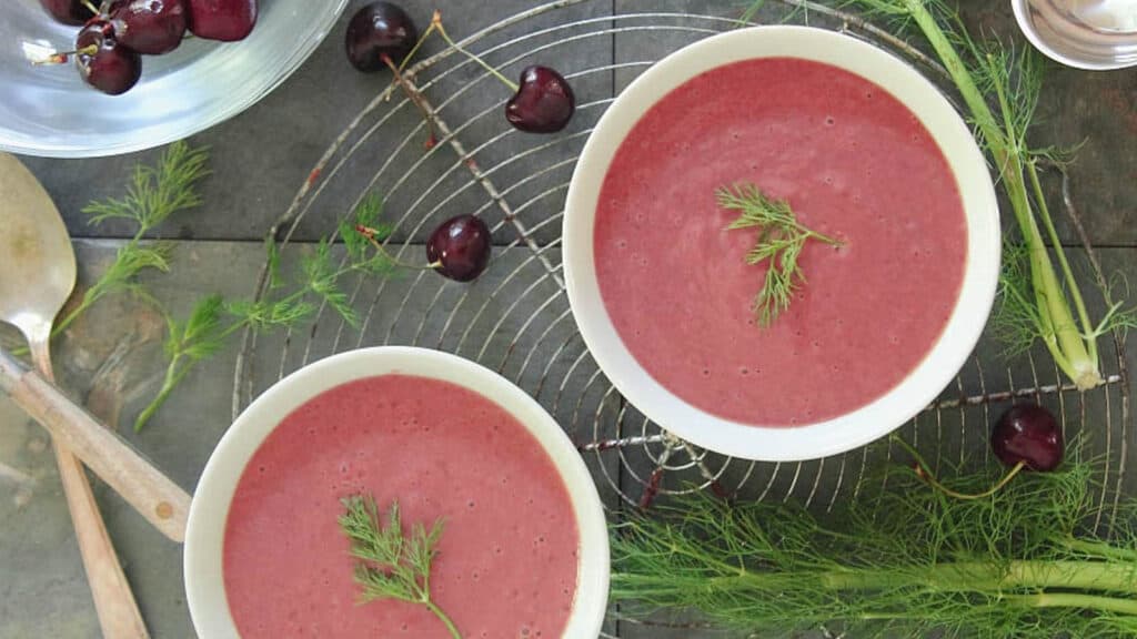 Chilled cherry fennel soup in bowls with fresh fennel on the side.