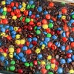 Chocolate dump cake topped with colorful M&Ms.