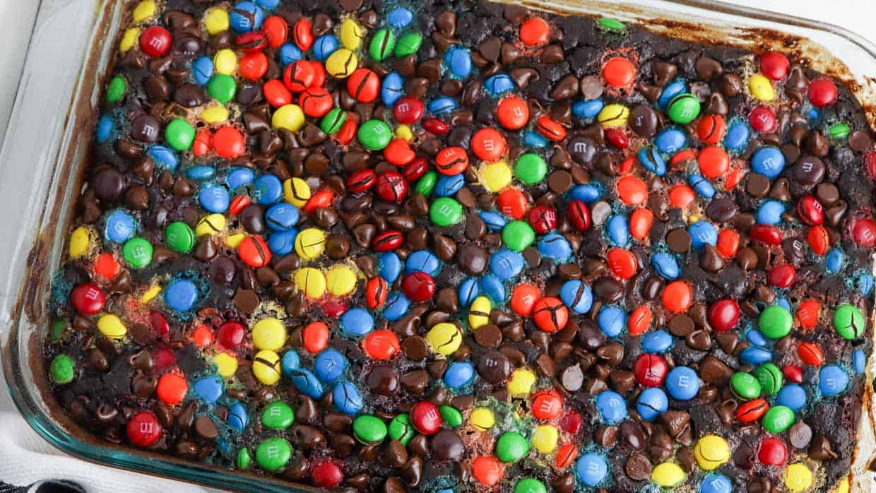 Chocolate dump cake topped with colorful M&Ms.