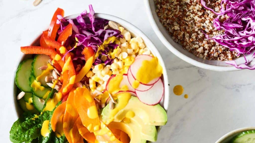 Top view of a white bowl filled with a medley of colorful veggies.