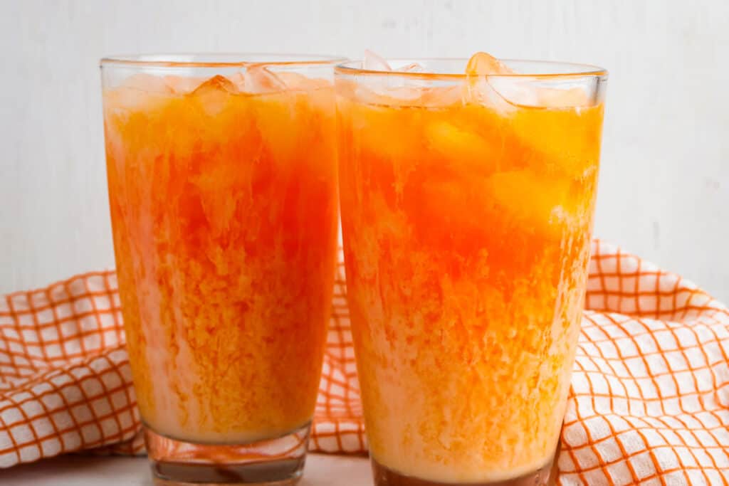 Orange soda with white coffee creamer in glasses with ice.