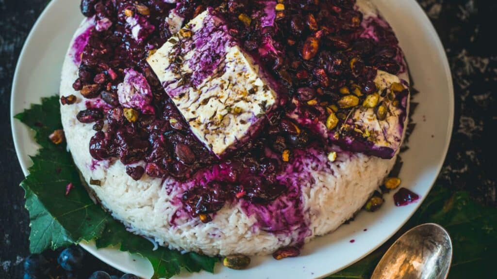 top view of rice on rice leaves with feta on top.