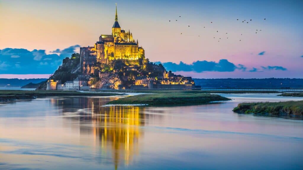 A castle rising out of water in France.