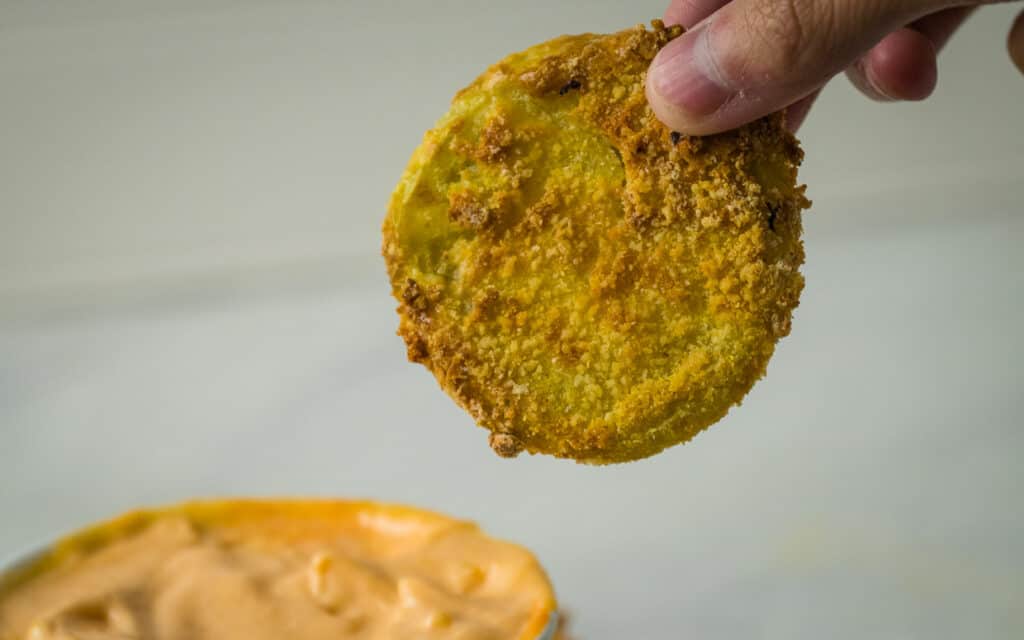 Breaded and fried green tomato slice.