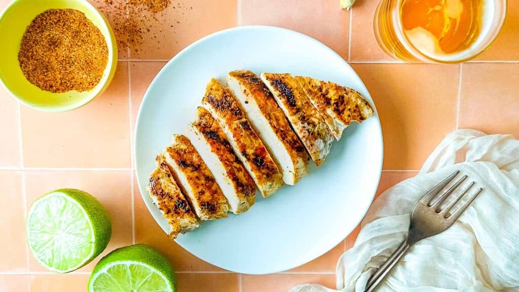 Grilled and sliced chile lime chicken on a white plate.