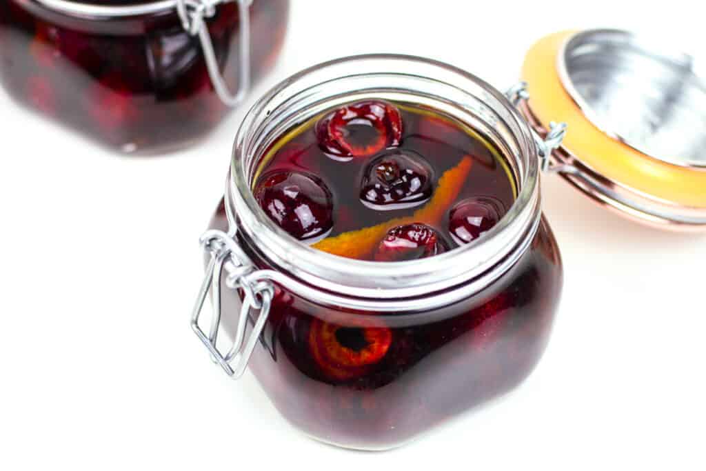 Cocktail cherries in a glass fliptop jar.