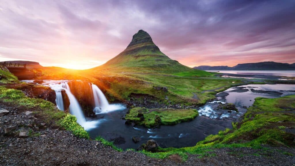 A green landscape with waterfalls in Iceland.