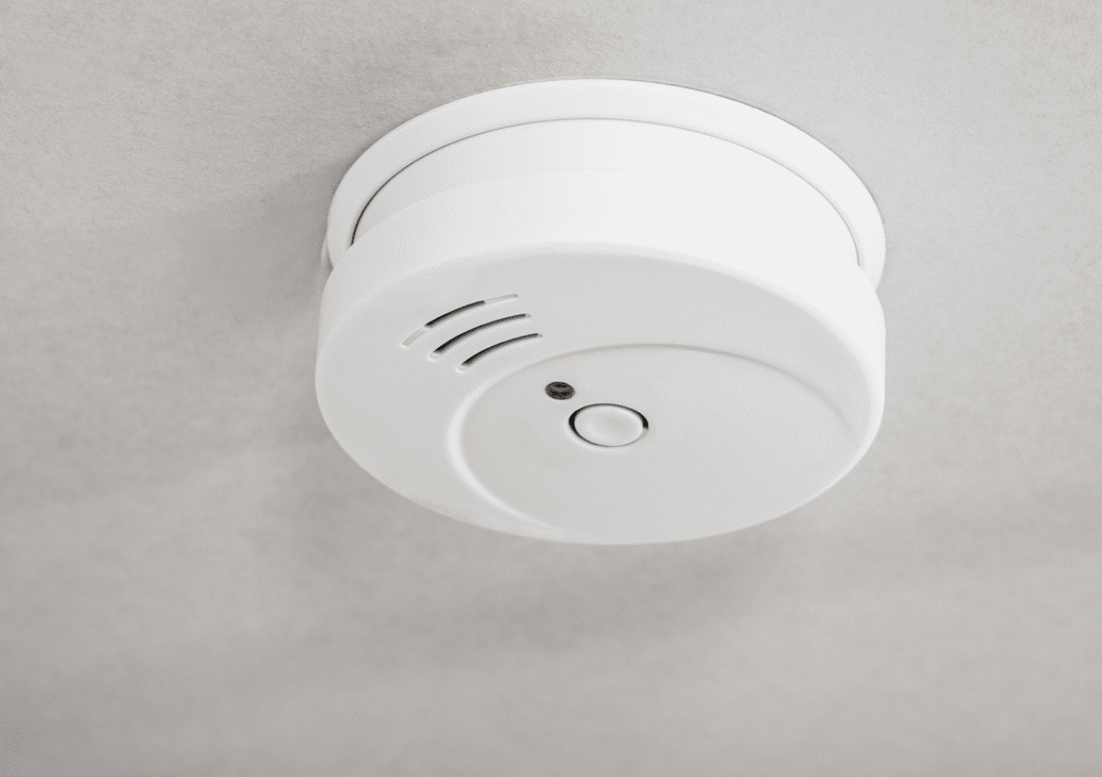 A smoke detector on a ceiling.