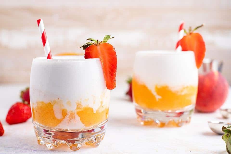 Glasses with a layered mango cocktail. 