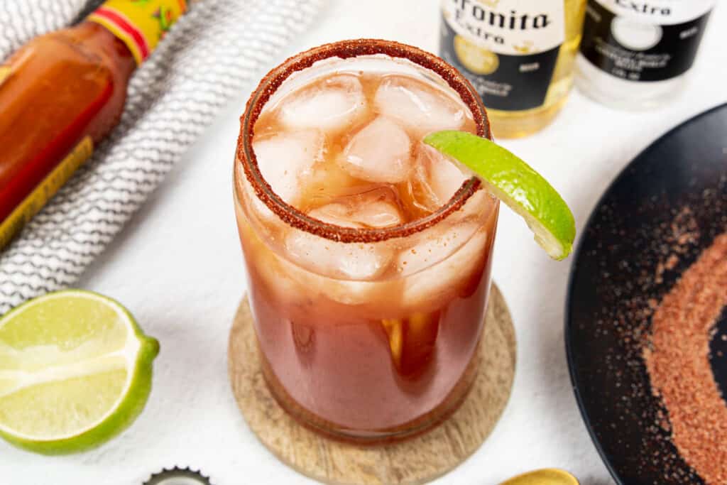 beer bottles, rim salt and hot sauce with a michelada cocktail.