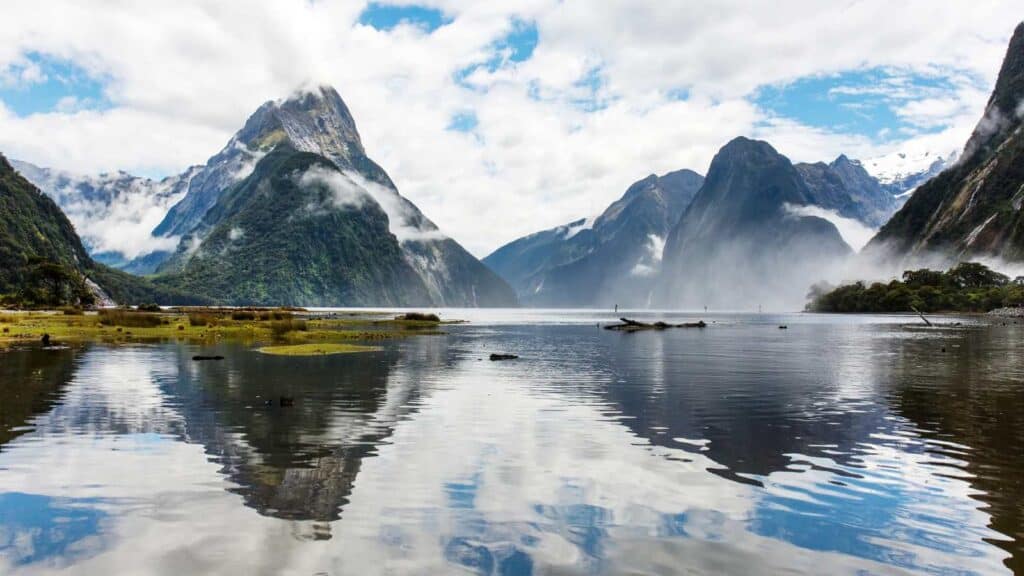 Mountains rising out of water in New Zealand.