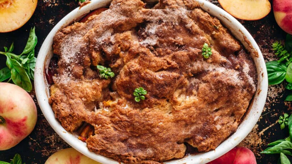 overhead of peach cobbler on baking sheet.