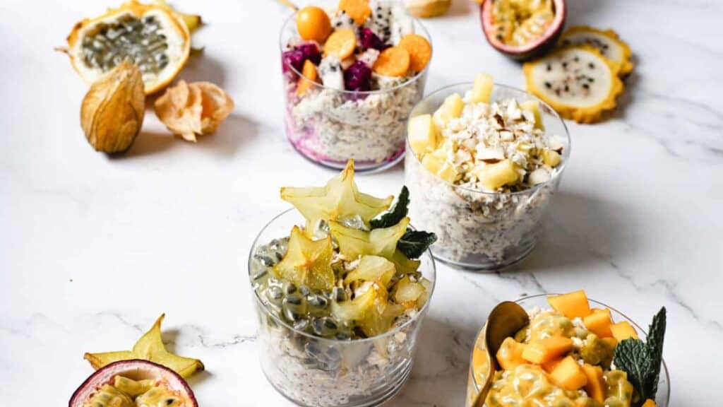 Four combinations of vegan overnight oats with fruit.
