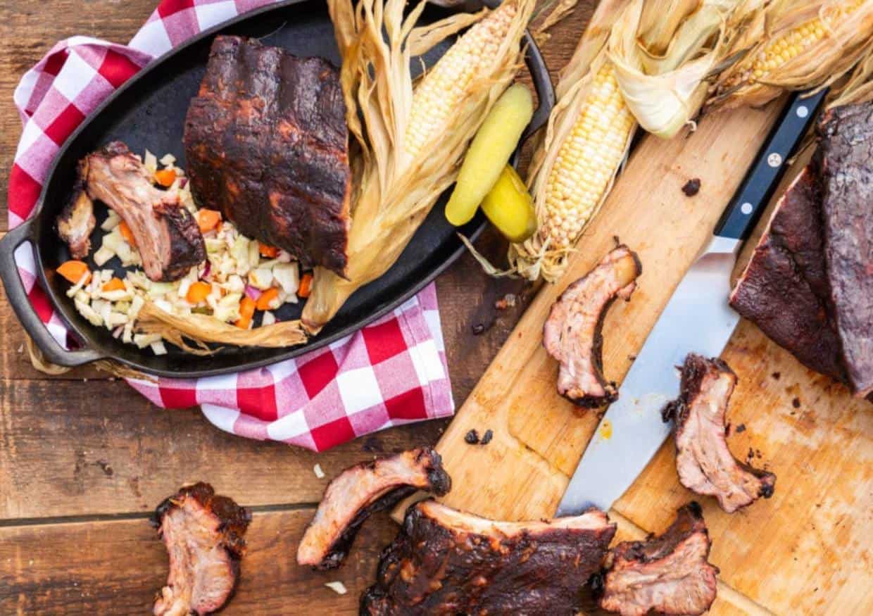 Overhead shot of grilled corn and ribs.