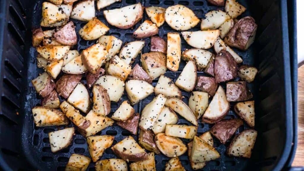 Air fried red potatoes in an air fryer basket.