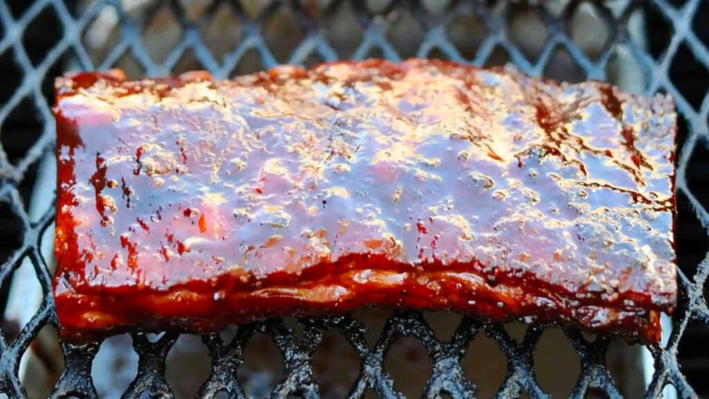 Slab of St. Louis-style ribs on smoker. 