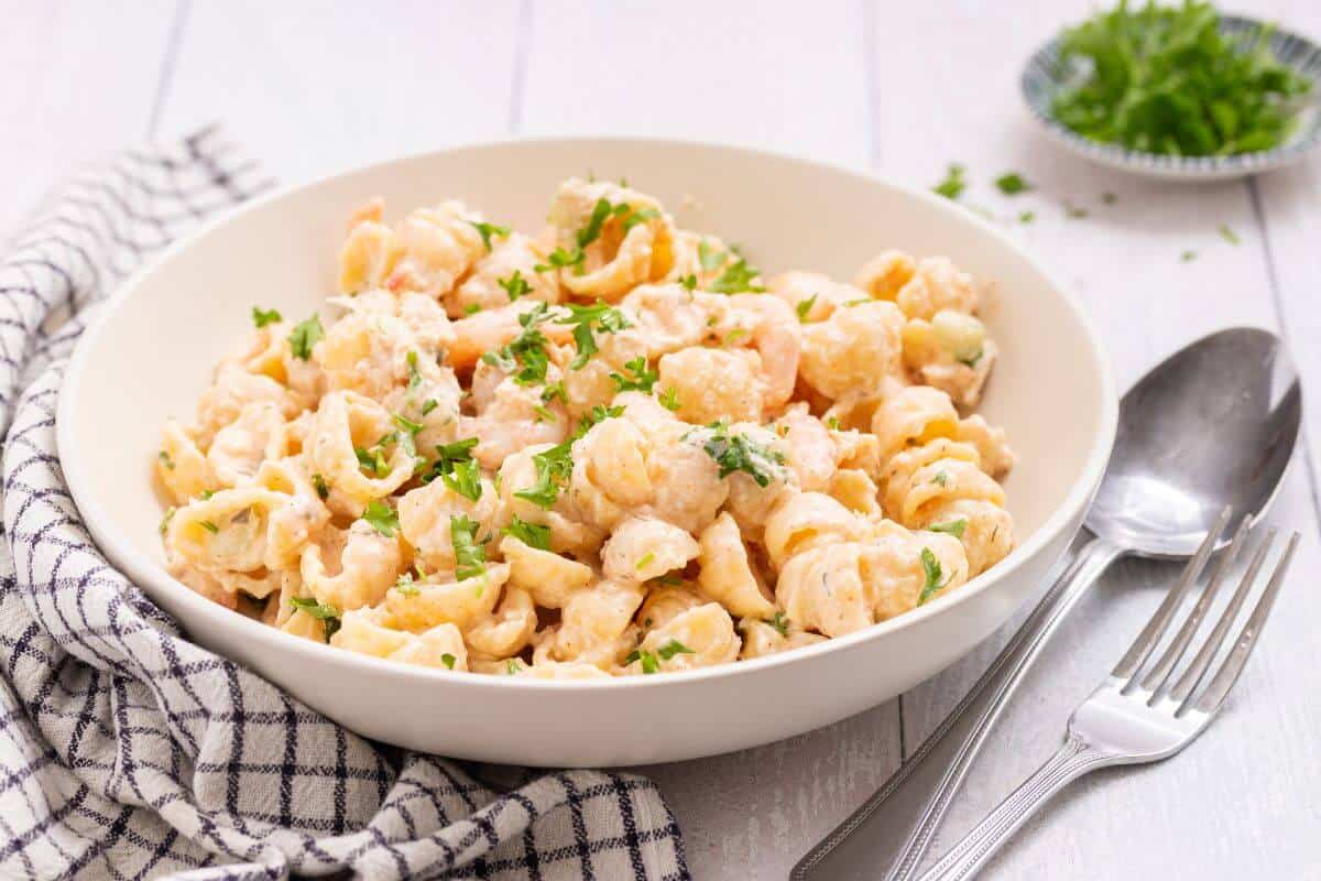 Seafood pasta salad in white serving bowl.
