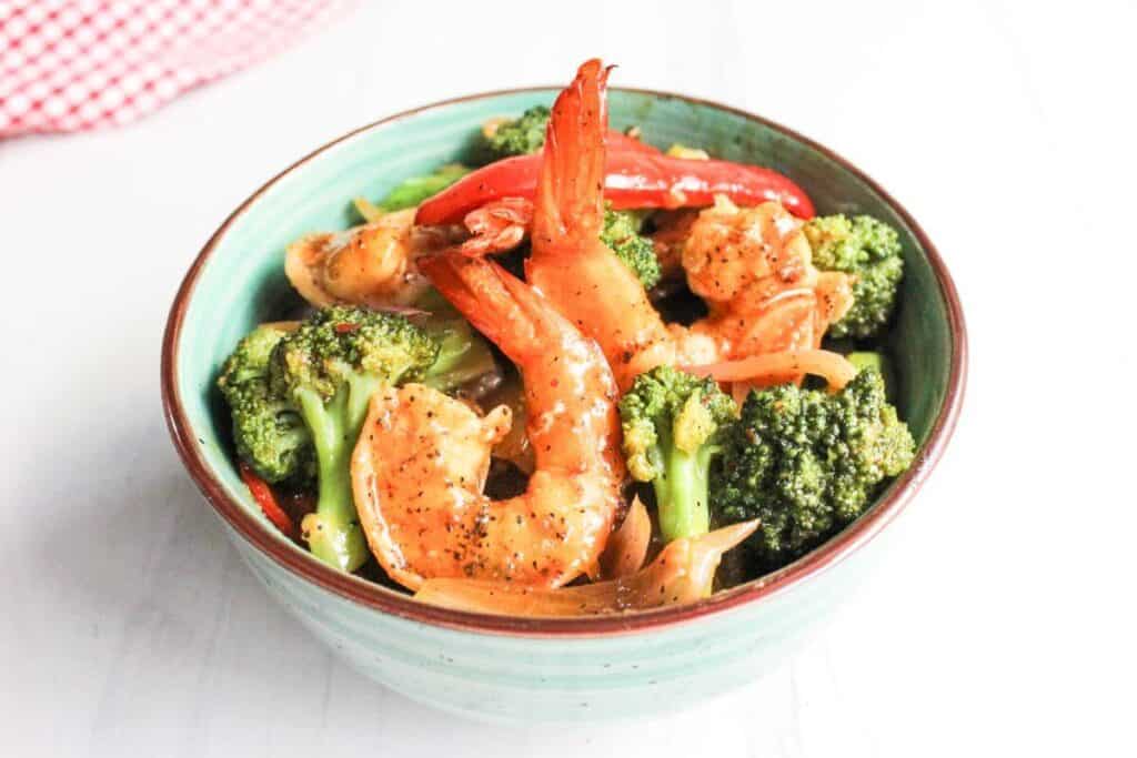 Shrimp and broccoli stir-fry in a bowl.