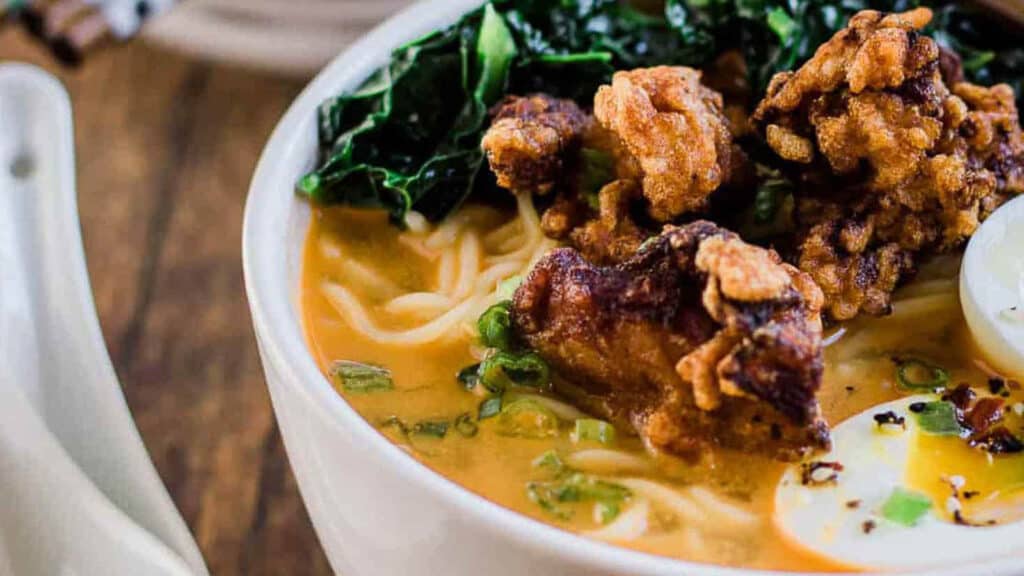 A bowl of spicy miso ramen with fried chicken.