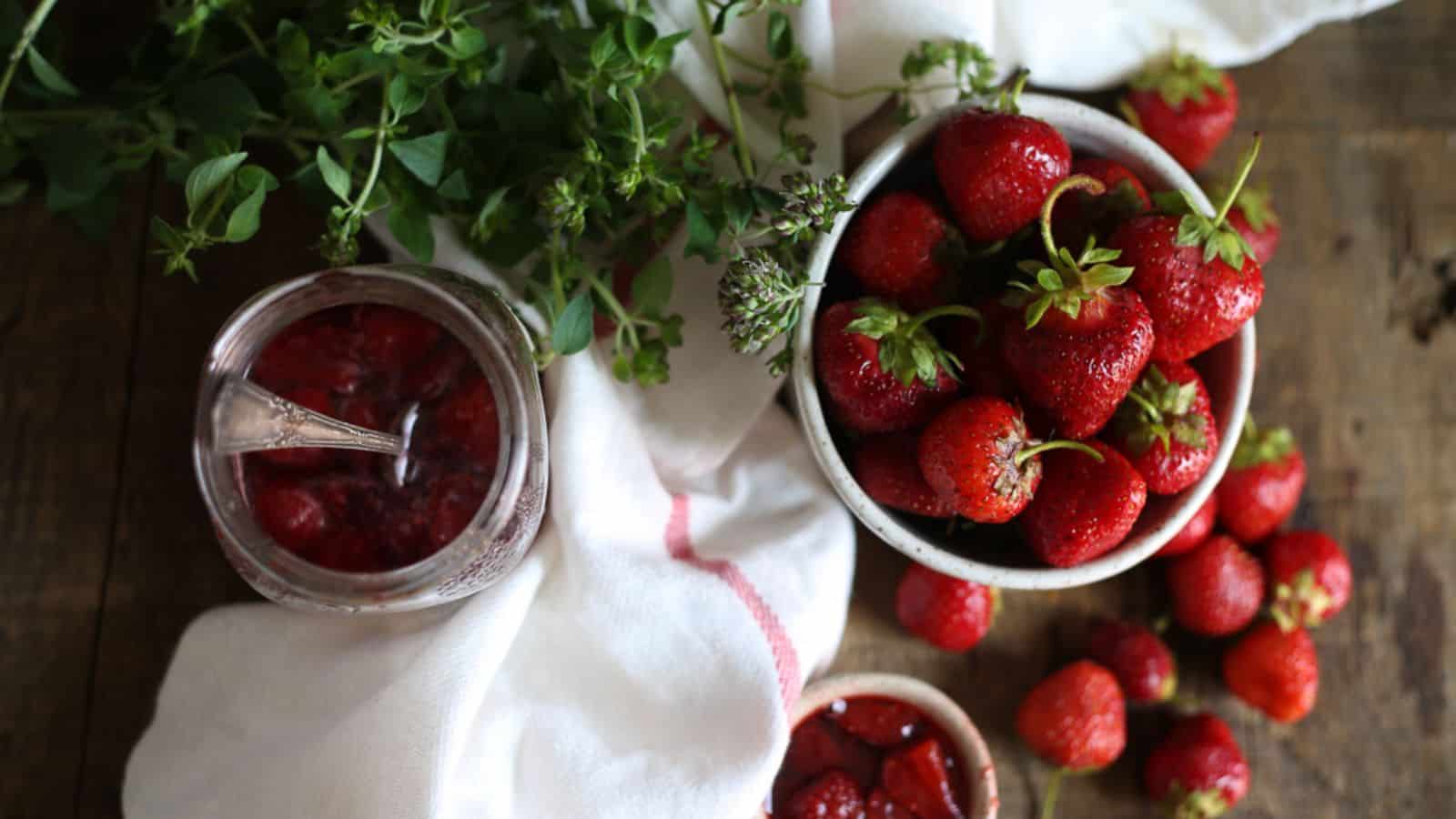 Strawberries and little pail of jam.
