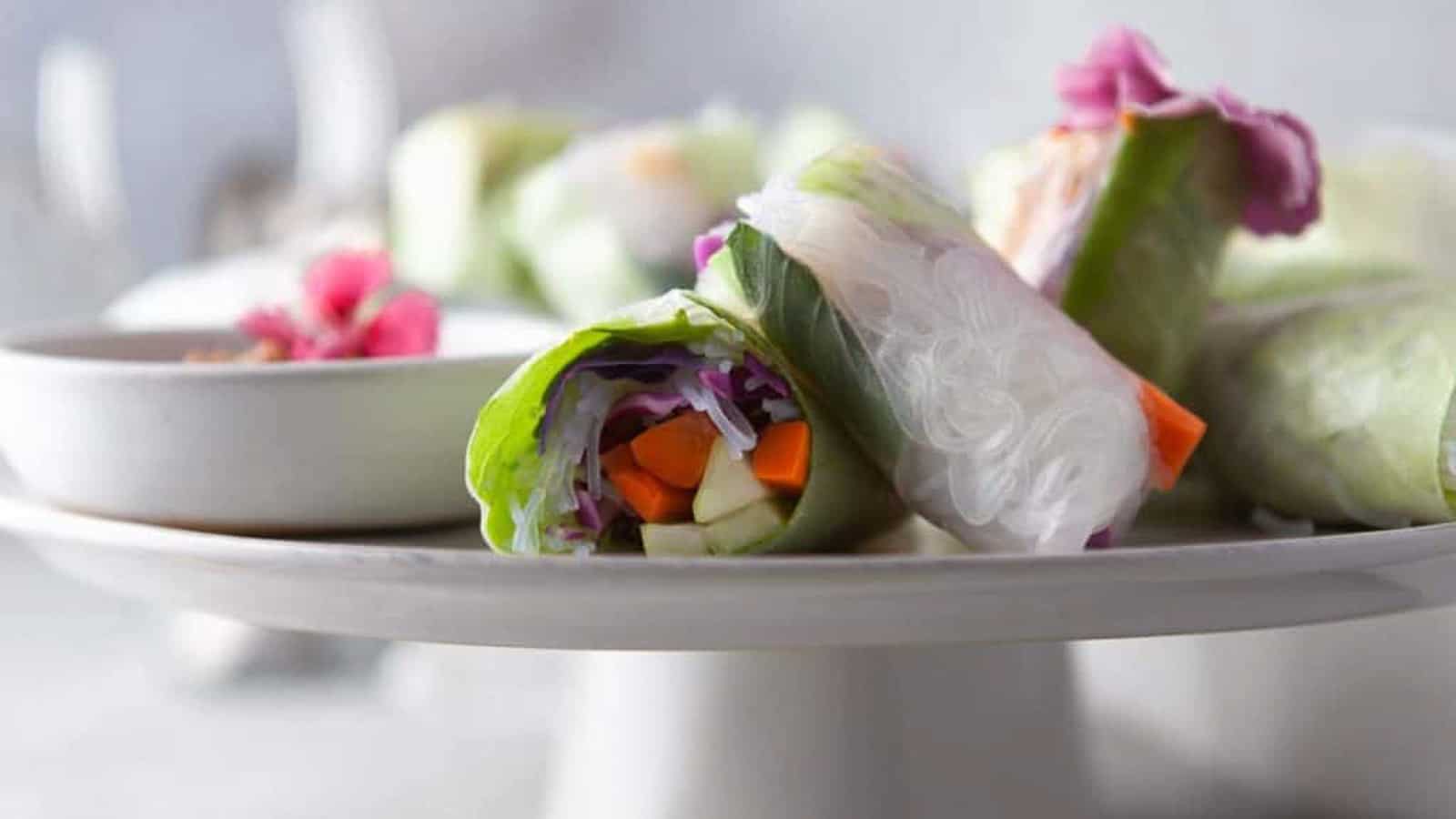 Low angle shot of vietnamese summer rolls with edible flowers.