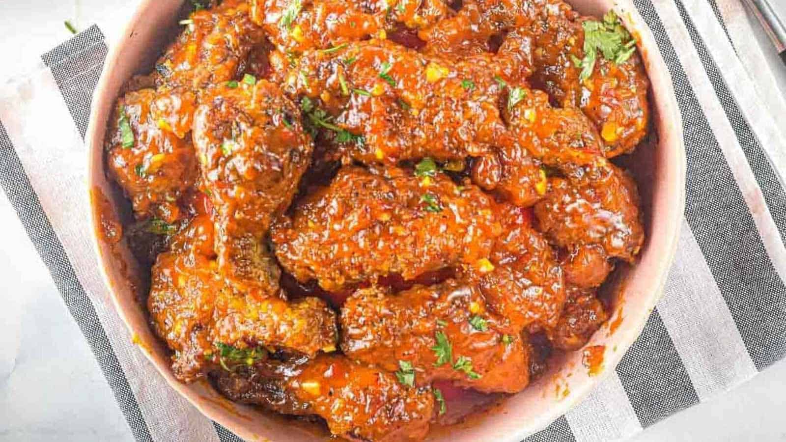 Bowl of Thai sweet chili wings on a gray and white napkin.
