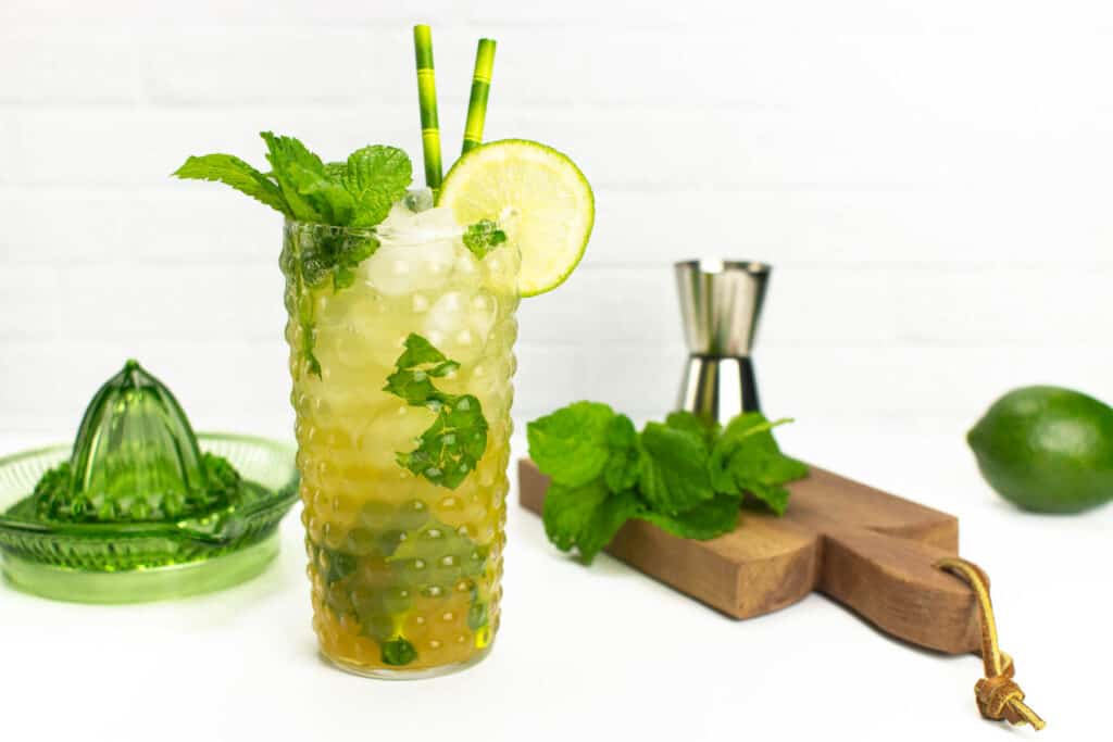 a virgin mojito on a wooden board with mint and a lime